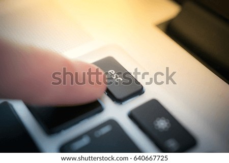The finger pushes a escapt button.