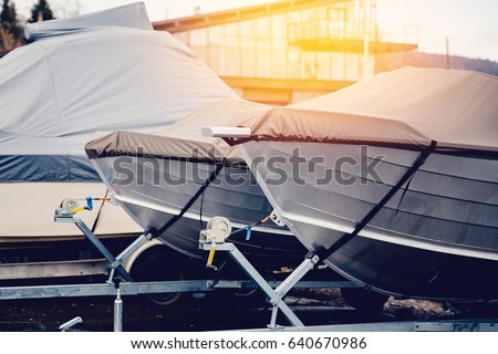 Row of boats in storage for the winter under the awning. Warehouse on the boat pier. Concept preparation for winter. Royalty-Free Stock Photo #640670986