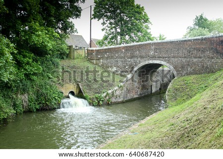 Bridge on the canal at Wootton Rivers Wiltshire England. Lock overflow in action.