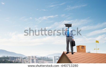 Faceless businessman with camera zoom instead of head standing on house roof