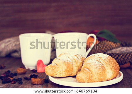 Two cups of tea and croissants in a romantic setting. Romantic breakfast.
