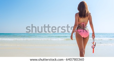 Beach vacation snorkel girl snorkeling with mask and fins. Bikini woman relaxing on summer tropical getaway doing snorkeling activity with snorkel tuba flippers sun tanning. Banner crop for copy space