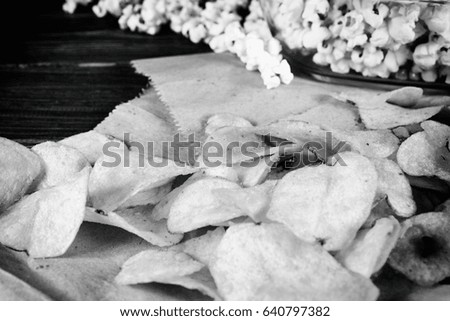 Loose popcorn and 3D glasses on a wooden background
