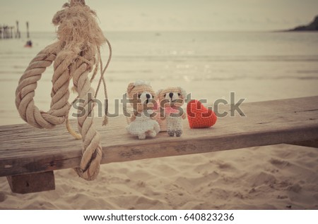 Teddy bears in love on the beach,this image for vacation wedding concept in vintage colour theme.
