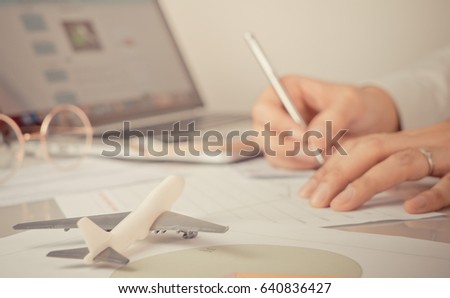 Business man is signing documents for his Business travel trip, Travel agency officer is reserving tickets for customer online. Business global communication concept. Royalty-Free Stock Photo #640836427