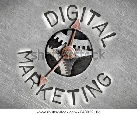 Macro photo of pointer and tooth wheel mechanism with DIGITAL MARKETING letters imprinted on metal surface