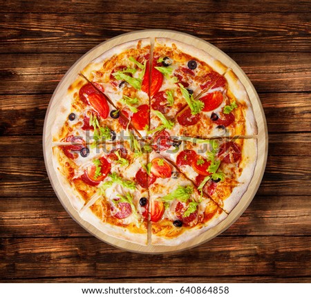 Pizza pepperoni deluxe. on the  wooden table.This picture is perfect  to design your restaurant menus. Visit my page.You will be able to find an image for every pizza sold in your cafe or restaurant.
