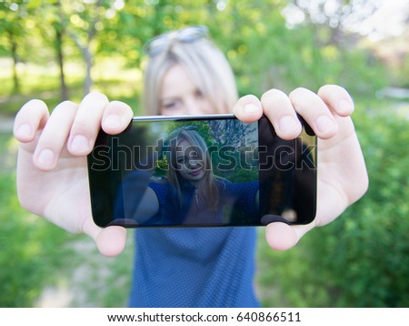 The girl does selfie front. The result is visible on the screen