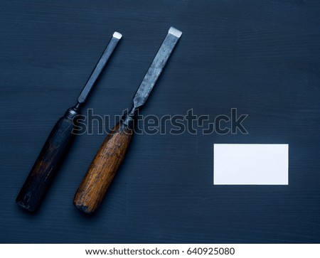 carpenter tools with business card on dark wooden background. 