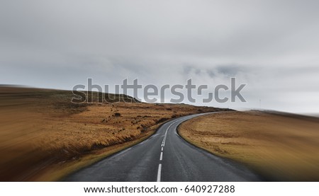 Country road in cloudy day with speed motion on border