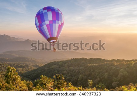 Hot air balloon over the mountain at sunset