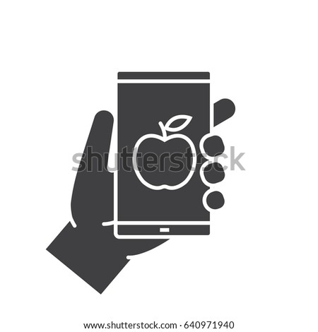 Hand holding smartphone glyph icon. Silhouette symbol. Smart phone dieting app. Negative space. Vector isolated illustration