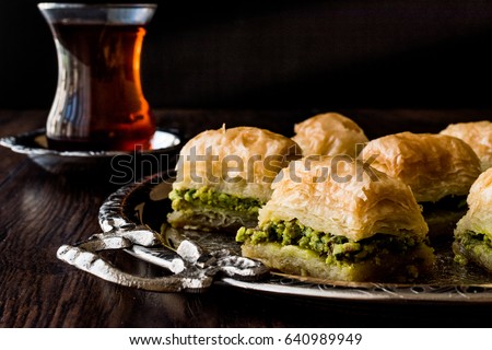 Turkish Dessert Baklava with tea on silver tray. Royalty-Free Stock Photo #640989949