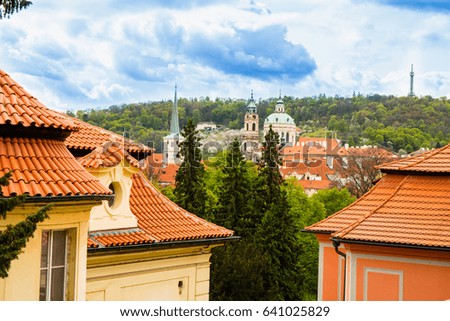 Vintage Prague roofs on the background cloudy skies.