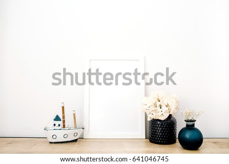 Front view blank mock up of photo frame with trendy stuff at white background. Minimalistic decorated home office concept.