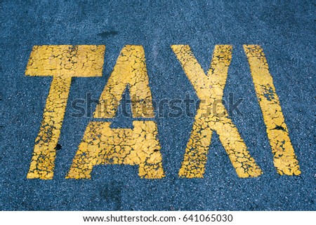 Taxi stand sign on asphalt parking lot