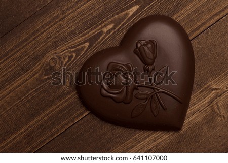 Chocolate in the shape of heart on a wooden background love valentines 
