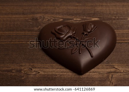 Chocolate in the shape of heart on a wooden background love valentines 