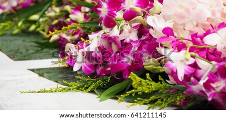 Purple and white orchid flowers are arranged for Buddha worship on Buddhist Holy Day