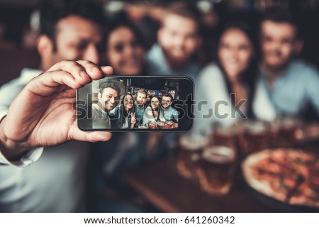 Selfie time! Handsome friends making selfie and smiling while resting at pub. Royalty-Free Stock Photo #641260342