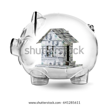 Piggy bank with house made of money on white background. Financial savings concept