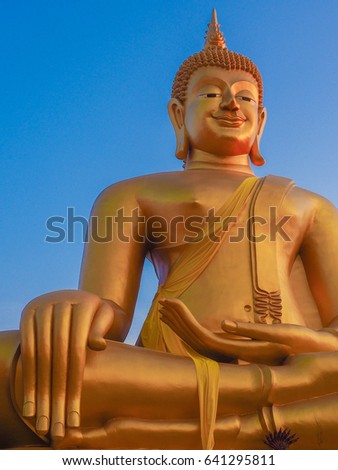 big gold den buddha on blue sky background