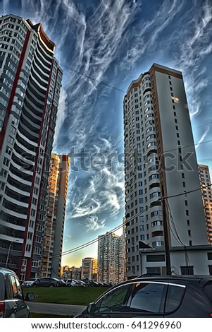 High-rise buildings, new buildings at sunset against a beautiful blue sky with clouds. Urban urban landscape.