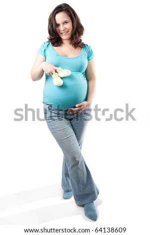 Pregnant woman holding baby shoes on white background