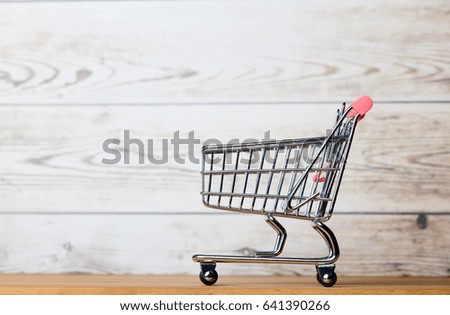 photo of beautiful shopping cart on the wonderful white studio background