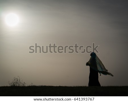 Silhouette of  woman with her scarf