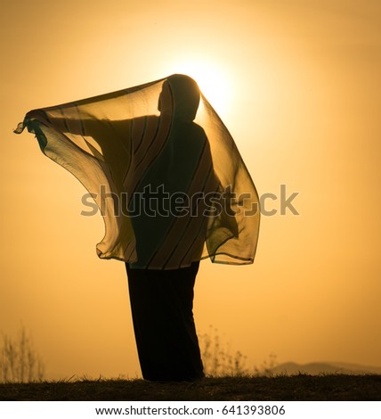 Silhouette of Muslim woman with her scarf