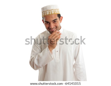 Smiling friendly ethnic man wearing a traditional embroidered robe with ruby buttons and a white and gold embroidered topi hat.  White background. Royalty-Free Stock Photo #64141015