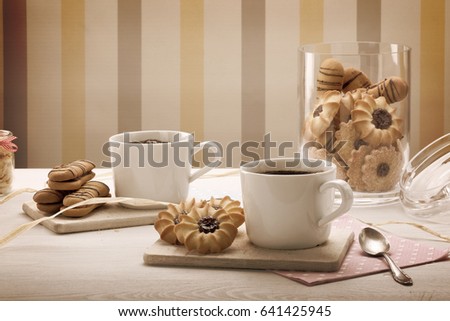 Vintage cup of coffee with crunchy cookie on the table and empty space for text
