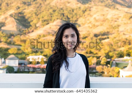 Asian girl Travel and lifestyle. Mountain range villages in sunset. 
