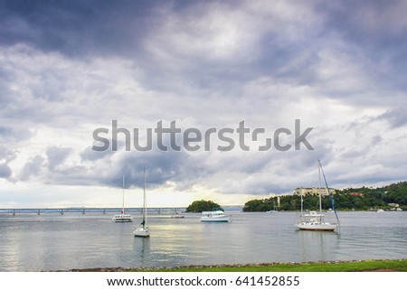 sail boats near the cost with palm trees in cloudy weather. Samana, Dominican Republic