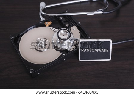 A stethoscope scanning for lost information on a hard drive disc with RANSOMWARE word on board