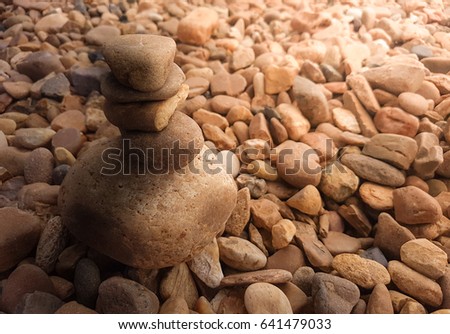 Close up balance of stone on stone pile with sunlight.