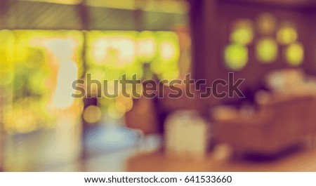 image of blur restaurant or coffee shop on day time with bokeh for background usage . (vintage tone)