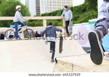Skateboard guys and bike on the ramp, urban landscape with the shoe on front