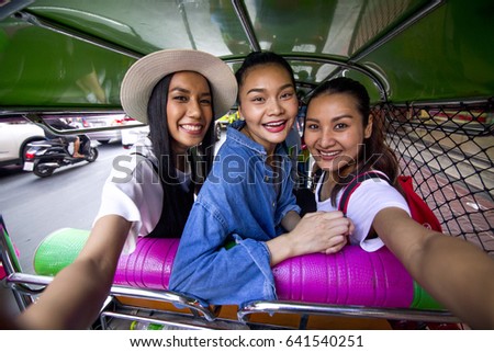 Girlfriends are taking selfie in tuk tuk while having vacation in Chinatown, Thailand