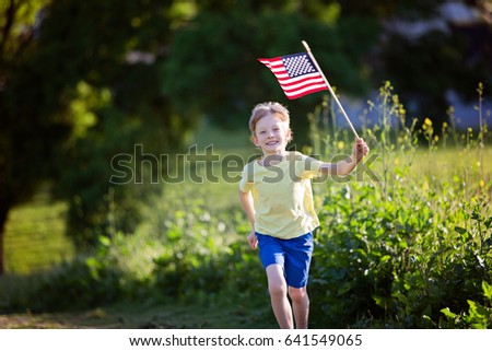 happy smiling little boy running with american flag, celebrating 4th of july