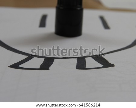 Smiley and lid of a marker