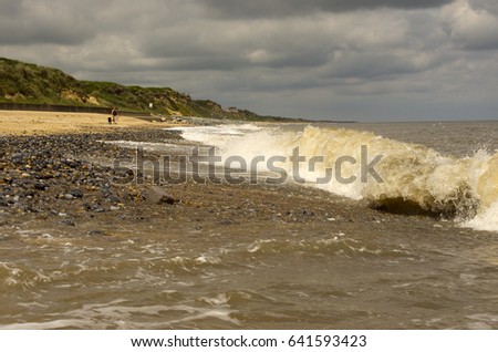 Waves breaking on a shingle beach.