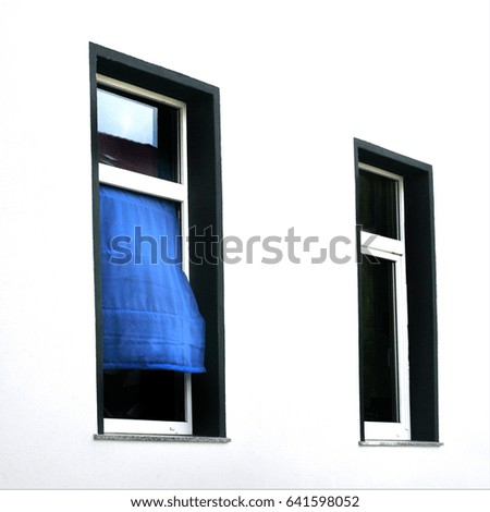 open window with a blue curtain