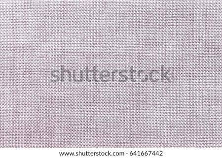 Light gray background of dense woven bagging fabric, closeup. Structure of the silver cloth with natural texture. Cloth backdrop.