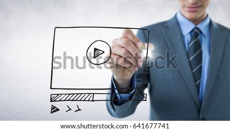 Digital composite of Business man mid section with marker and website mock up with flare against white wall