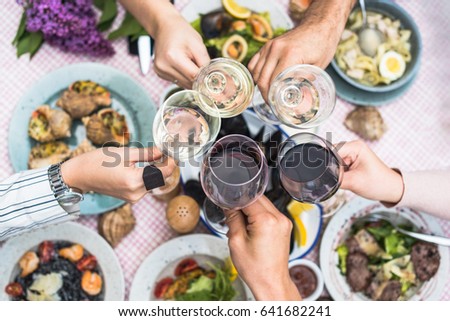Food Table Healthy Delicious Organic Meal Concept. Enjoying dinner with friends. Top view of group of people having dinner together while sitting at the rustic wooden table Royalty-Free Stock Photo #641682241