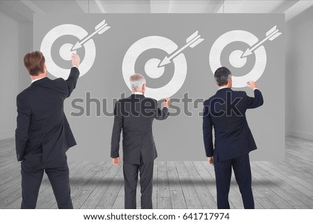 Digital composite of Digital composite image of business people drawing arrow with target symbol