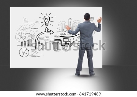 Digital composite of Rear view of professionals looking at diagrams on bill board