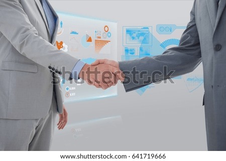 Digital composite of Cropped image business people doing handshake with interface graphics in background